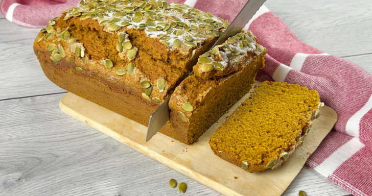 Pumpkin bread loaf on wood cutting board