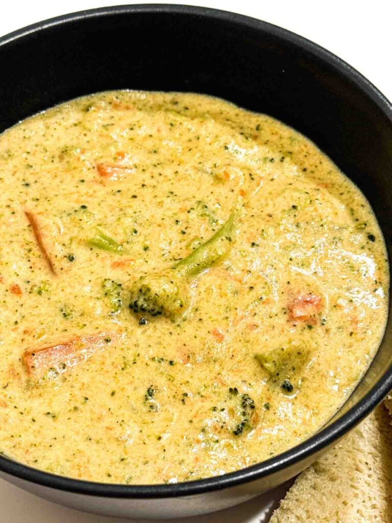 Copycat Broccoli Cheddar from Panera. Soup is in a black bowl