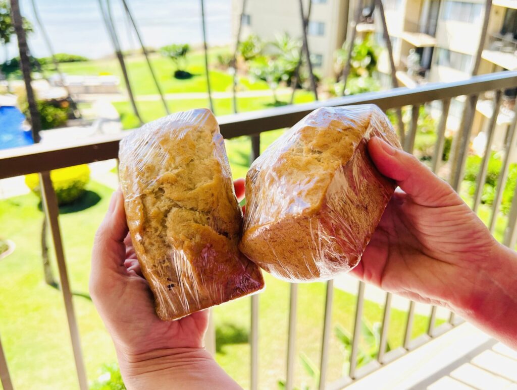 holding 2 banana breads in my hand from Aunt Sandi in Maui Hawaii