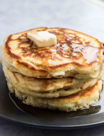 Stack of pancakes with butter and syrup on top