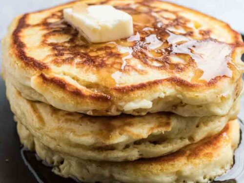 Stack of pancakes with butter and syrup on top