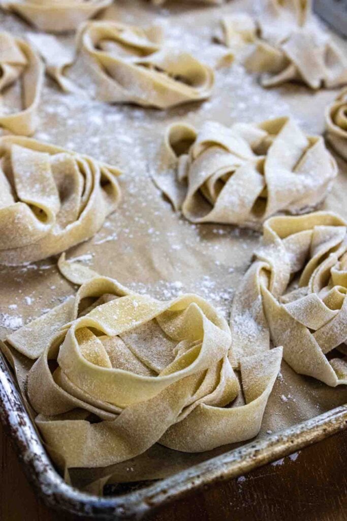homemade pasta on a baking sheet drying