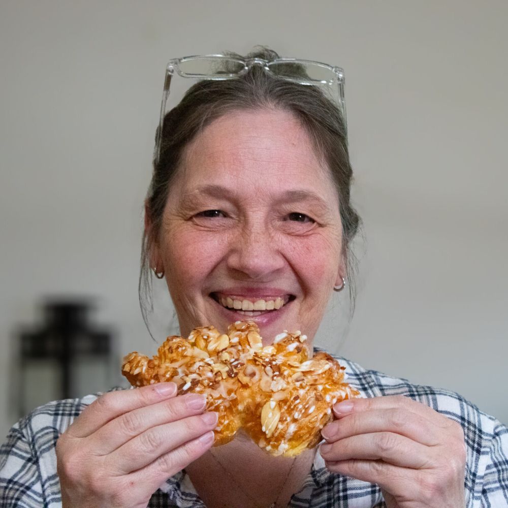 Debbie eating a bear claw pastry