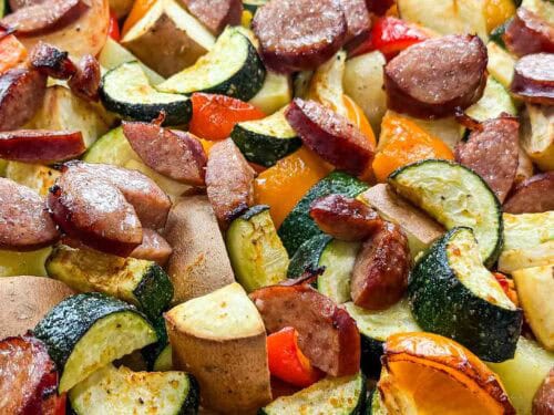 a sheet full of veggies and kielbasa sausage on top