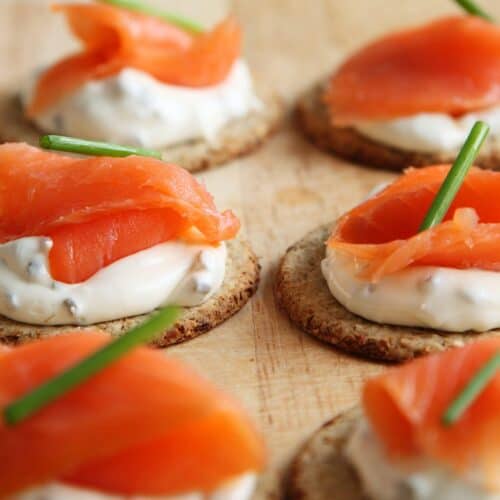 smoked salmon on cream cheese and crackers topped with some chive