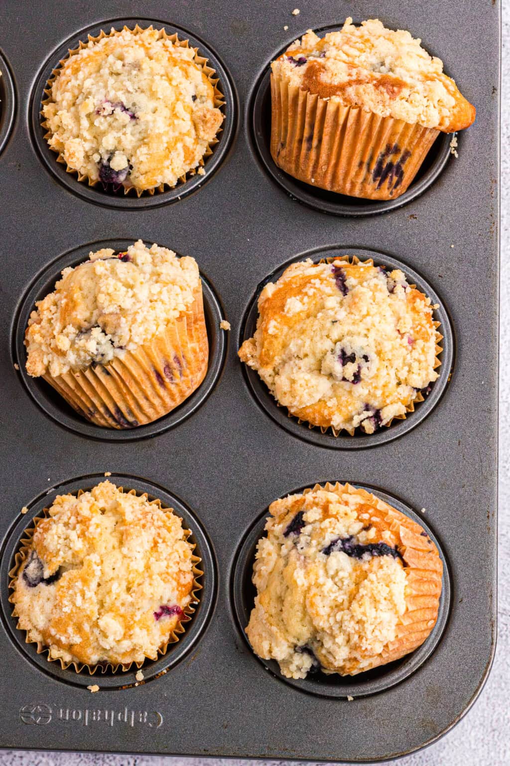 6 blueberry muffins in a muffin tin