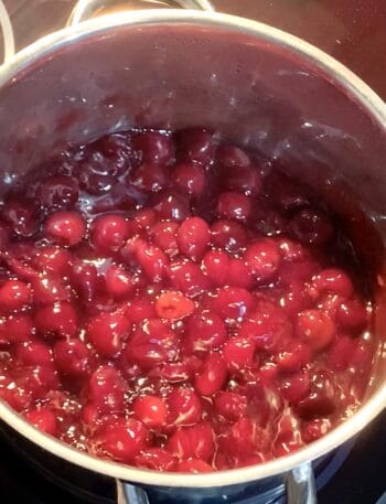 cherry pie filling in a stainless steel pot hot and ready