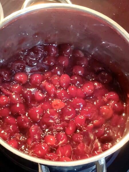 cherry pie filling in a stainless steel pot hot and ready