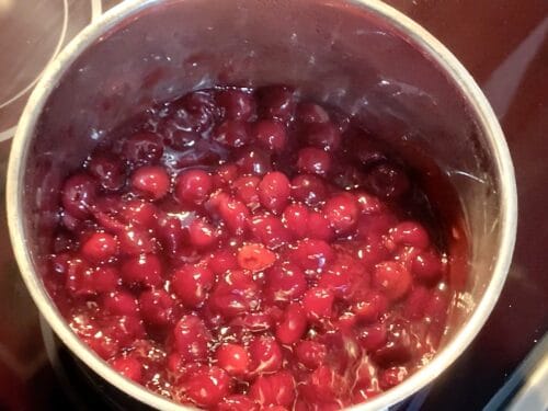 cherry pie filling in a stainless steel pot hot and ready