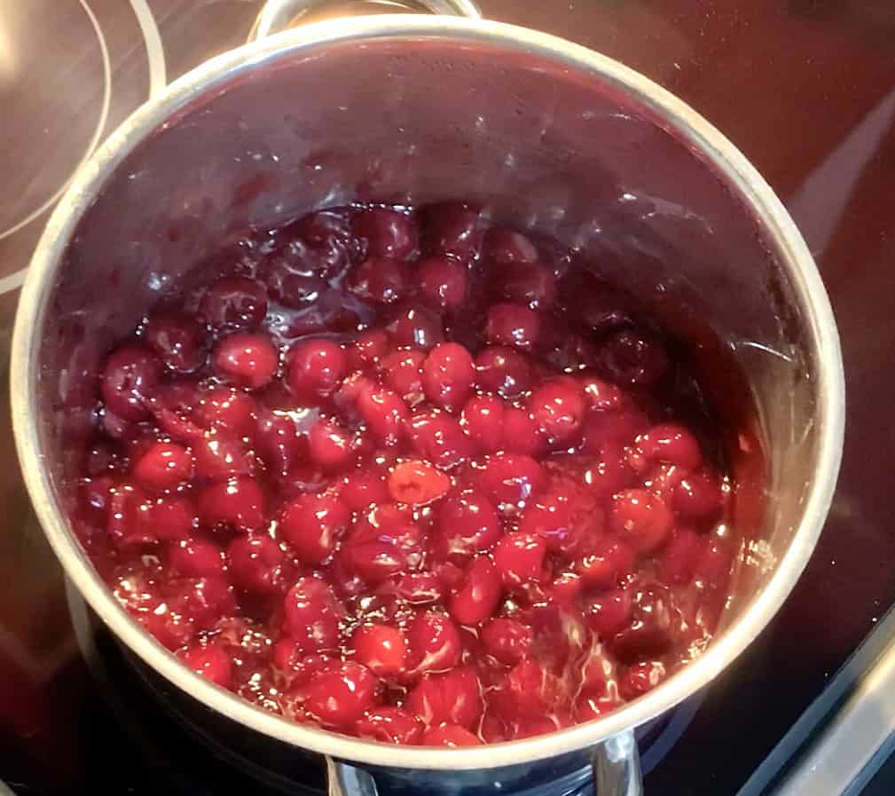 cherry pie filling in a stainless steel pot hot and ready