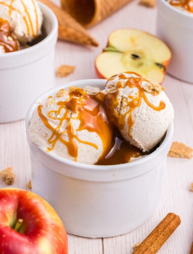 Apple Pie Ice Cream scoops in a white ramekin drizzled with caramel syrup
