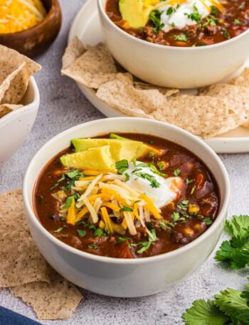 chilli topped with cheese in a white bowl