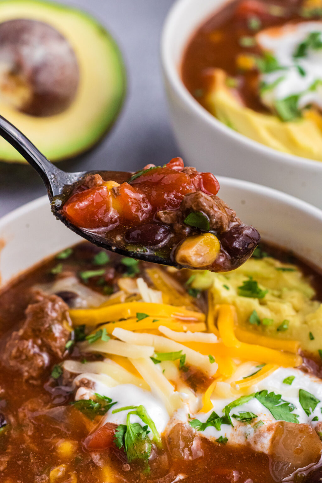 a spoonful of yummy chili on top of bowl of chili