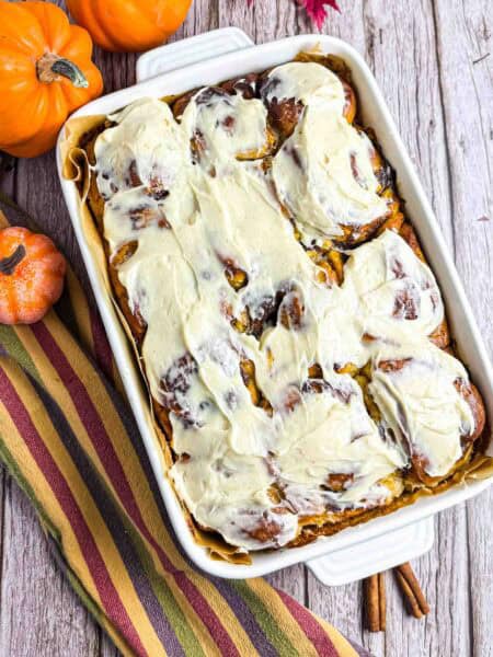 Cream Cheese Frosted Pumpkin Cinnamon Rolls in baking dish.