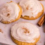 Pumpkin Cookies with cream cheese icing on a backing sheet