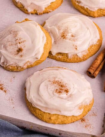 Pumpkin Cookies with cream cheese icing on a backing sheet
