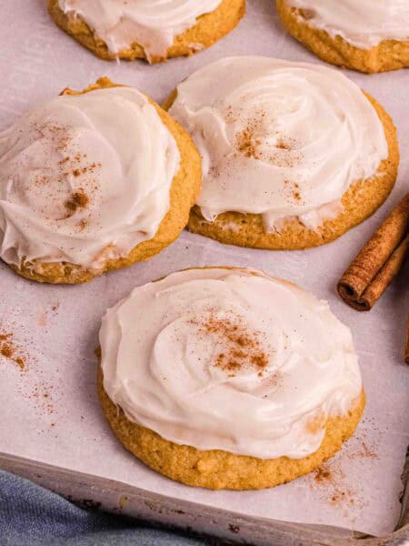 Pumpkin Cookies with cream cheese icing on a backing sheet