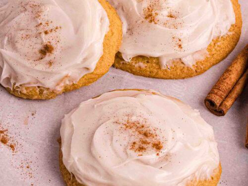 Pumpkin Cookies with cream cheese icing on a backing sheet