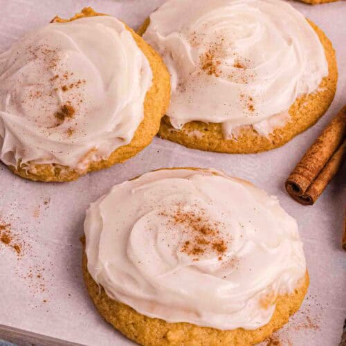 Pumpkin Cookies with cream cheese icing on a backing sheet