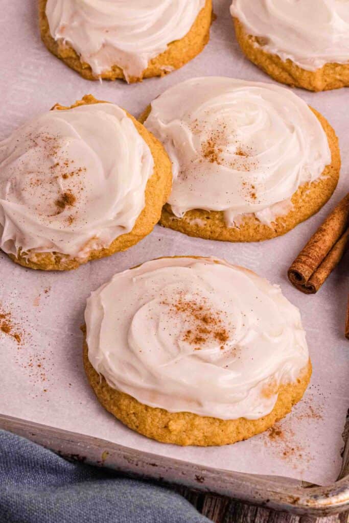 Pumpkin Cookies with cream cheese icing on a backing sheet
