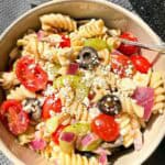 Bowl of Pasta Salad with a small bowl of Feta Cheese beside it