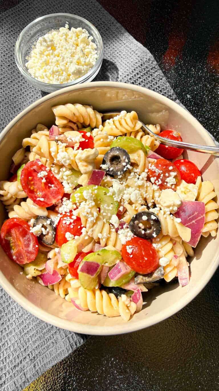 Bowl of Pasta Salad with a small bowl of Feta Cheese beside it
