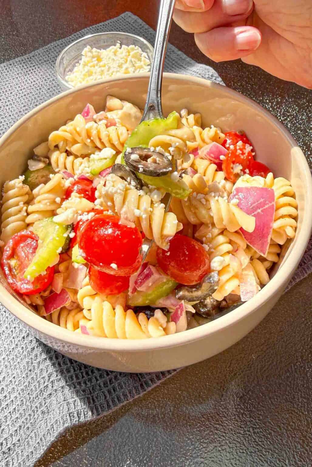 bowl of pasta salad with fork partially filled with pasta salad
