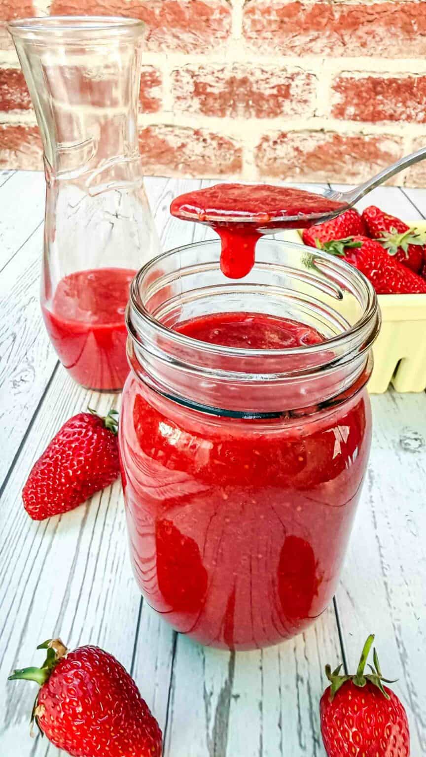 strawberry sauce dripping from a spoon
