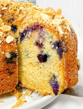slice of blueberry bundt cake with oat crumble topping