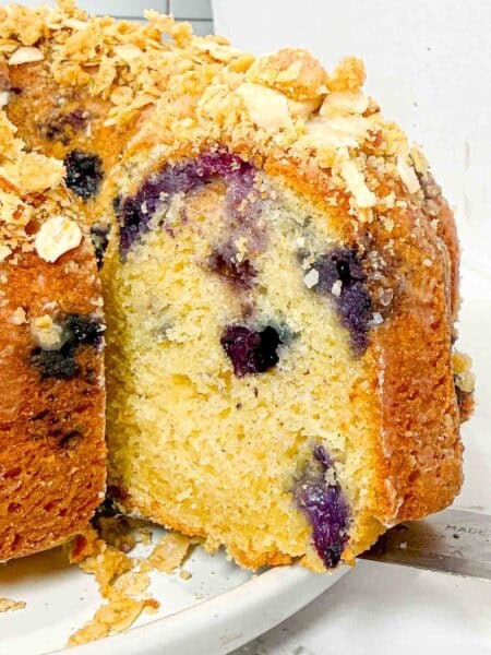 slice of blueberry bundt cake with oat crumble topping