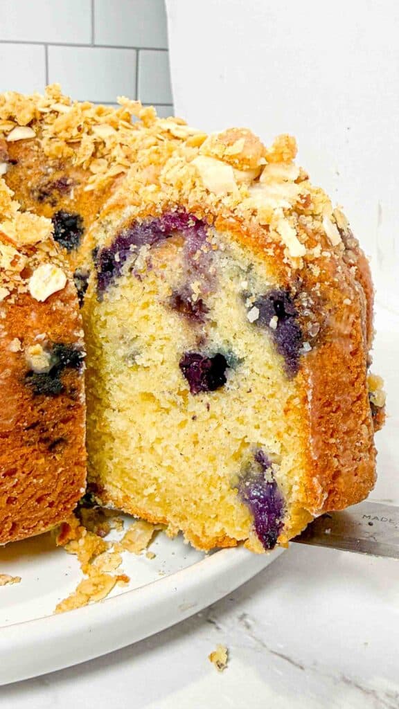 slice of blueberry bundt cake with oat crumble topping