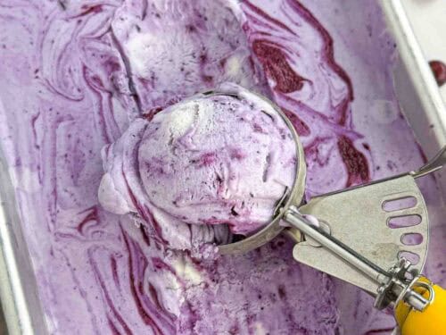 ice cream scoop in blueberry ice cream pan