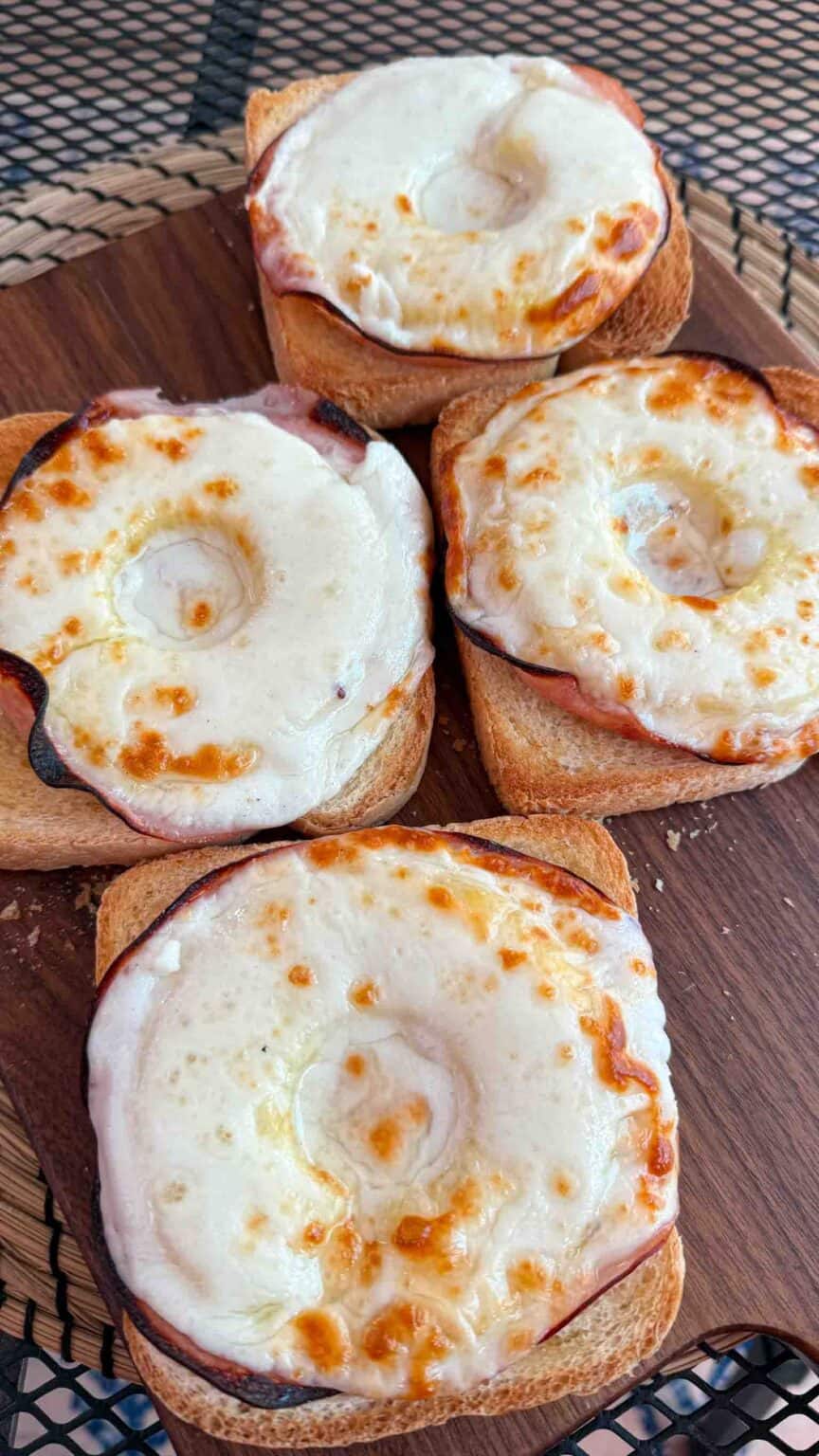 Ready to eat hot Toast Hawaii on a wooden board