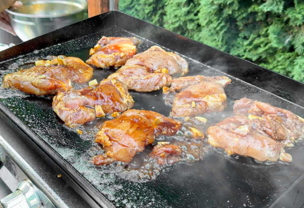 Chicken teriyaki searing on the griddle