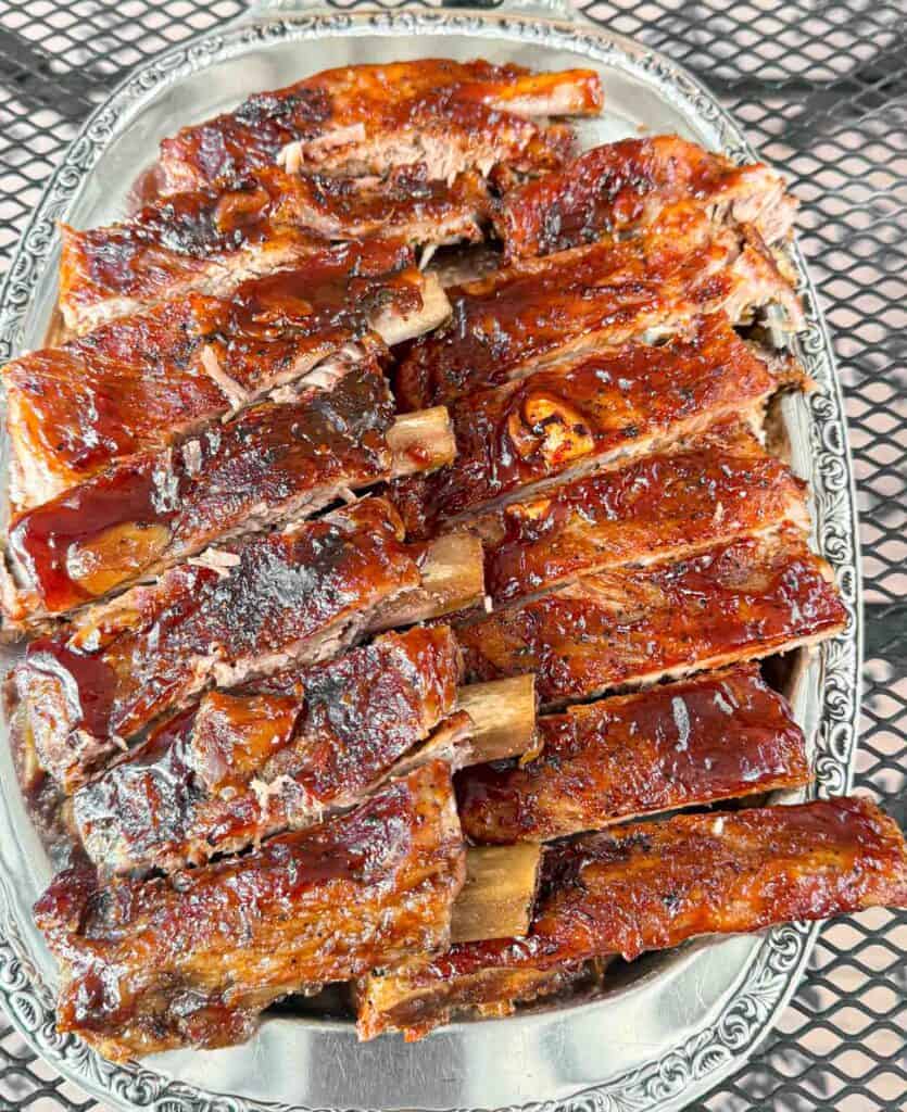 A big plate of oven baked barbecue brushed ribs so tender they fall of the bone