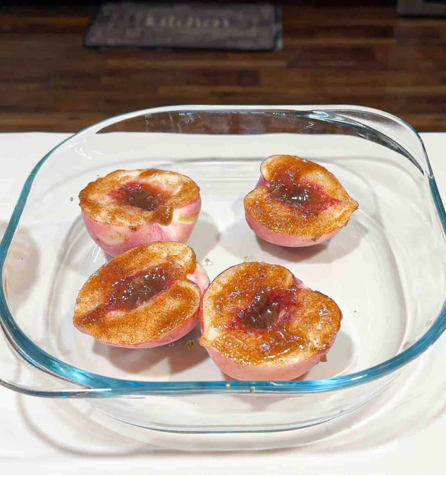 butter brushed peaches ready to grill