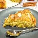 Slice of german apple cake on a black plate