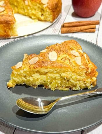 Slice of german apple cake on a black plate