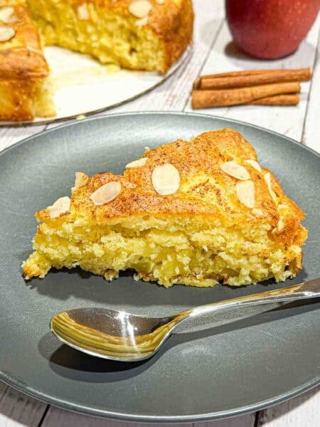 Slice of german apple cake on a black plate