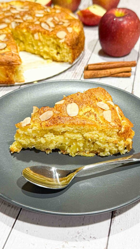 Slice of german apple cake on a black plate